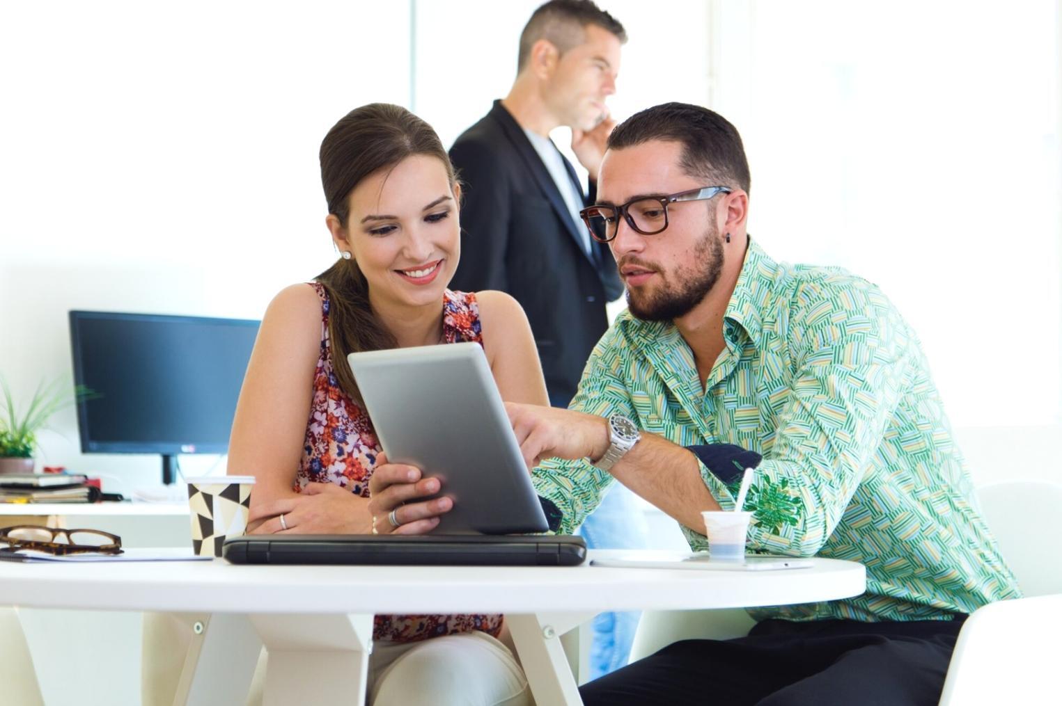 Investment reporting team collaborating on portfolio analysis